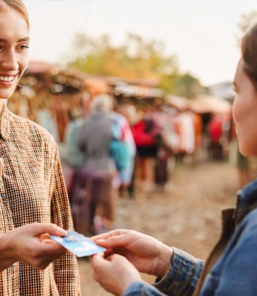 woman-paying-with-credit-card-outdoor-market